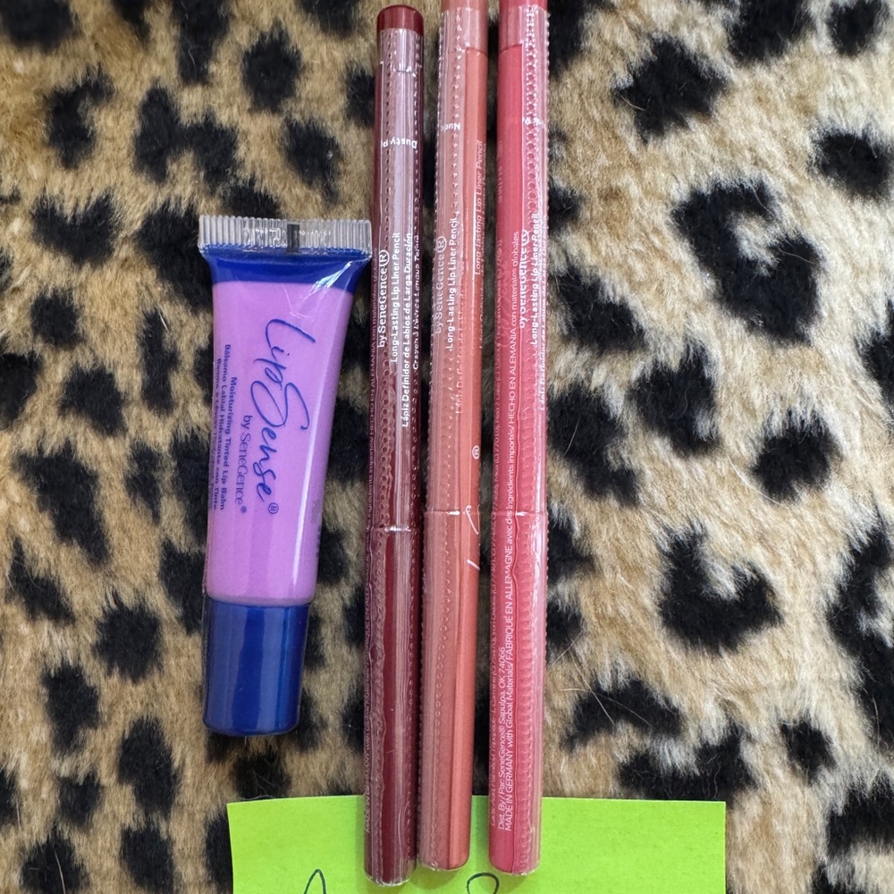 Three LipSense liners and one tinted lip balm